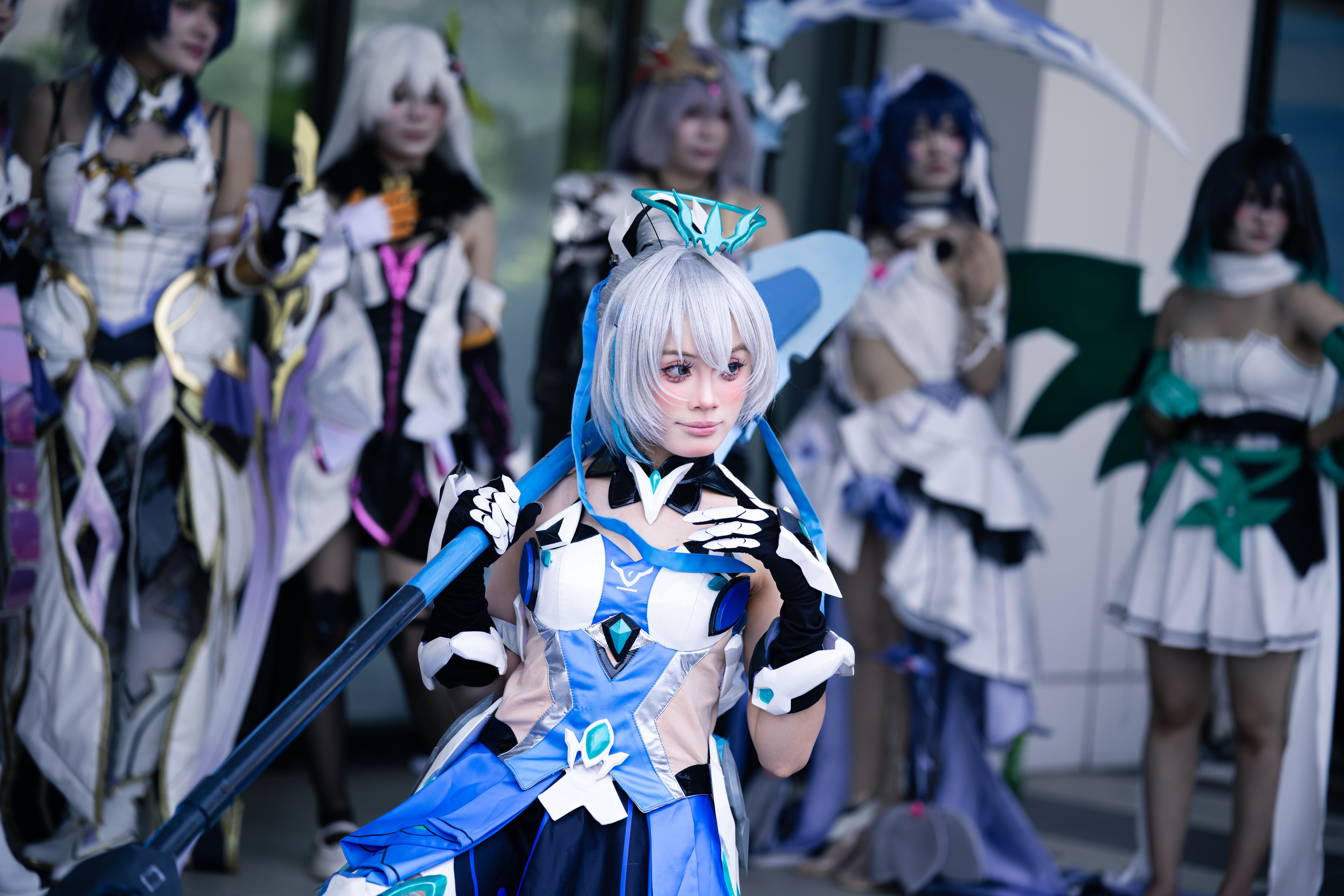 Cosplayers in elaborate fantasy-inspired costumes sharing their creativity at a convention