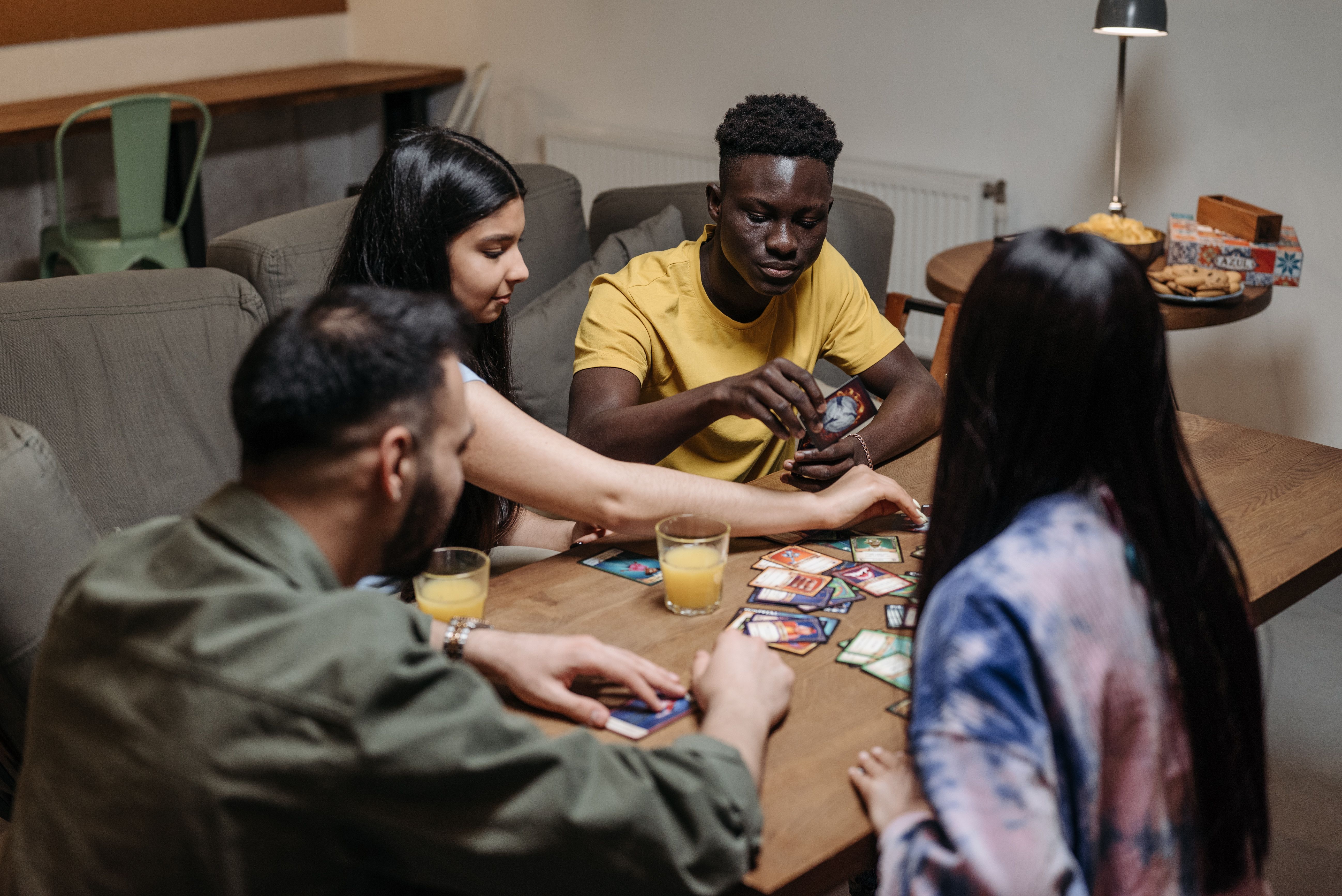 Friends gathered around a table playing a strategy game and enjoying time together