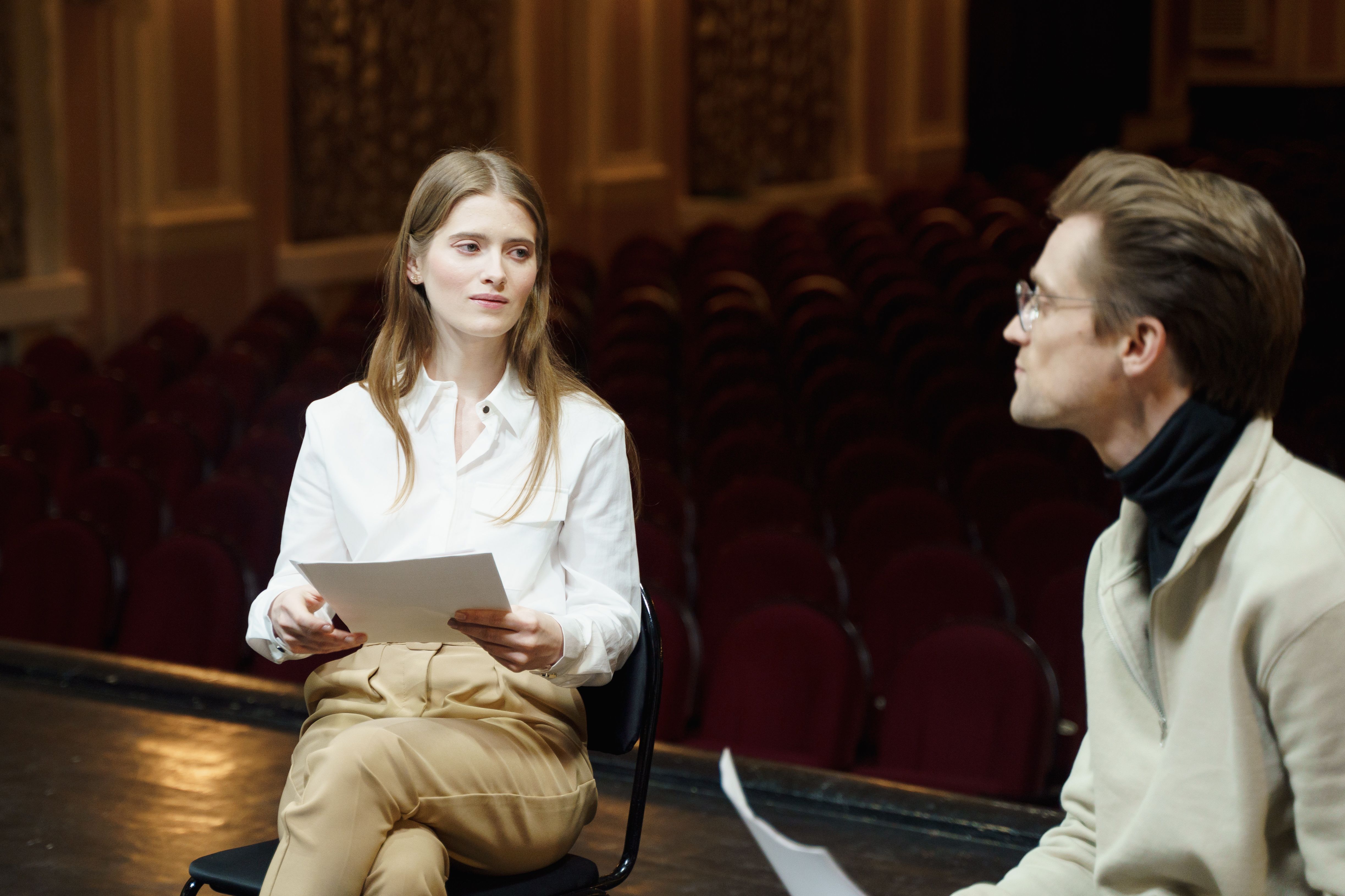 Two actors rehearsing a scene onstage, exploring characters through role-play